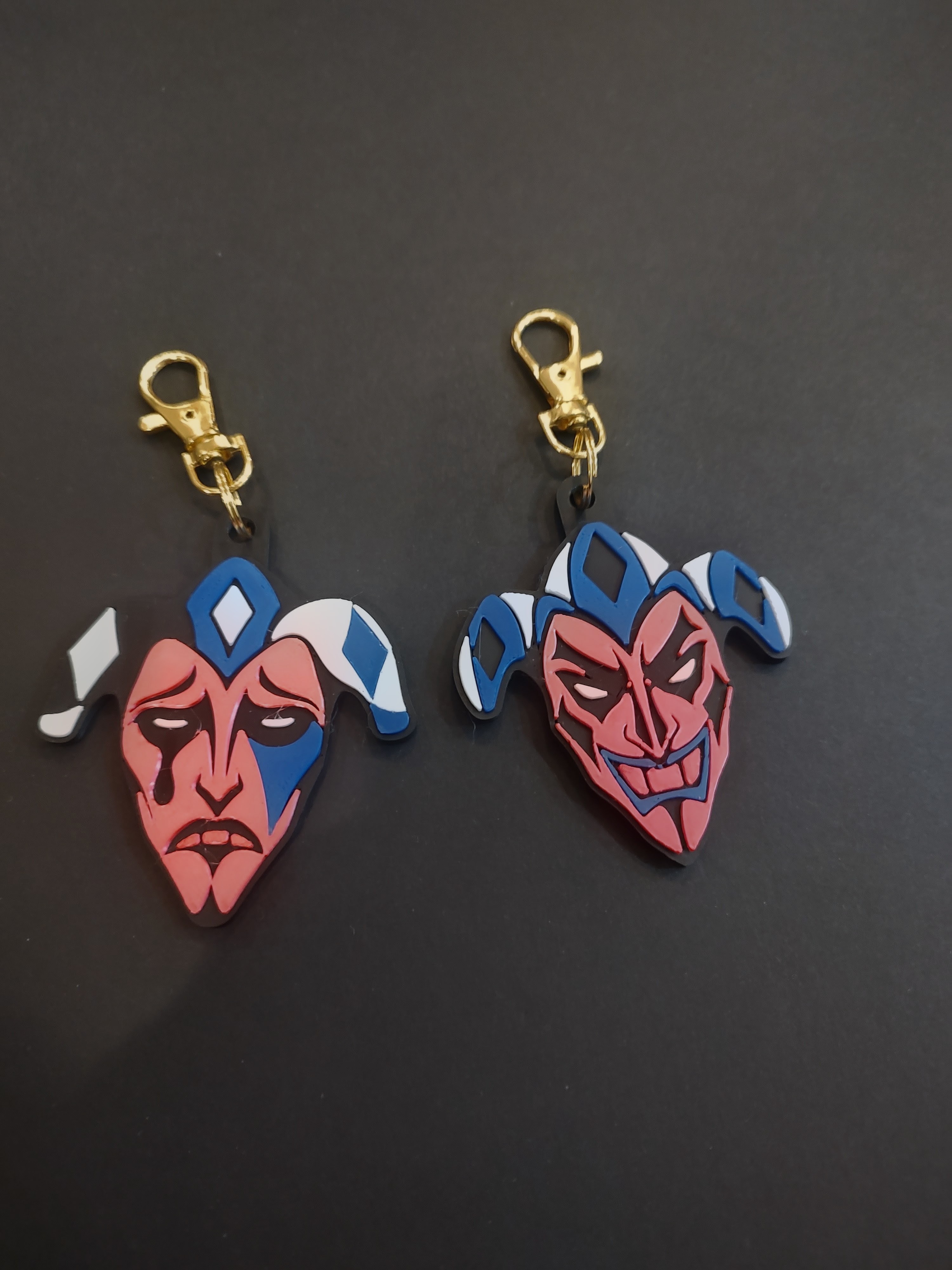 Two theatrical jester mask bag charms by MerchWT