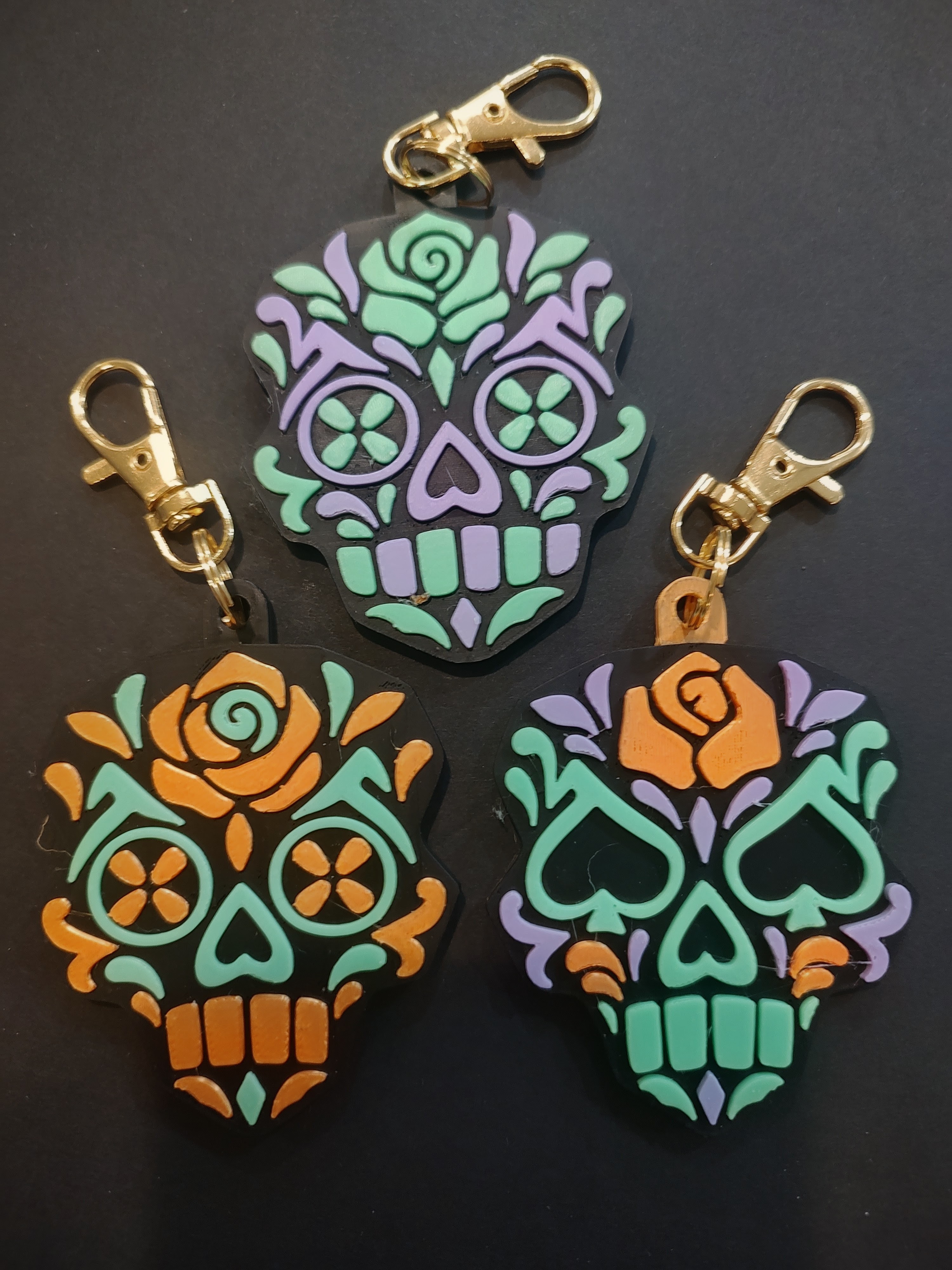 Three original MerchWT rose sugar skull bag charms with gold clasps