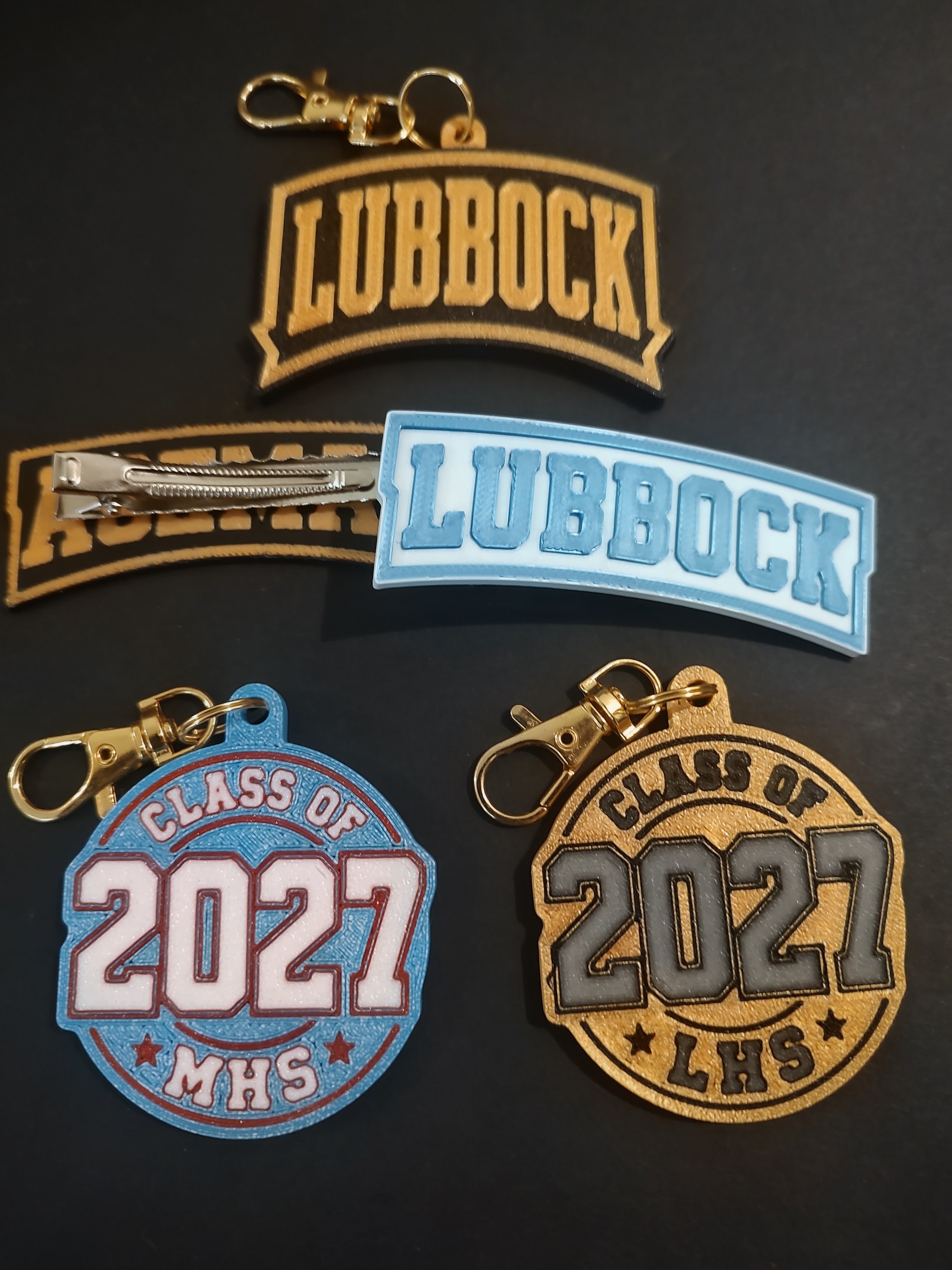 MerchWT custom hair clips, school keepsakes and town bag charms in finished sample designs